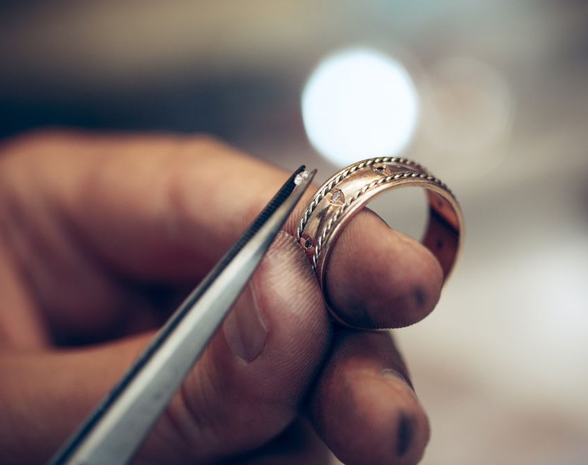 person puting ringstones on a ring